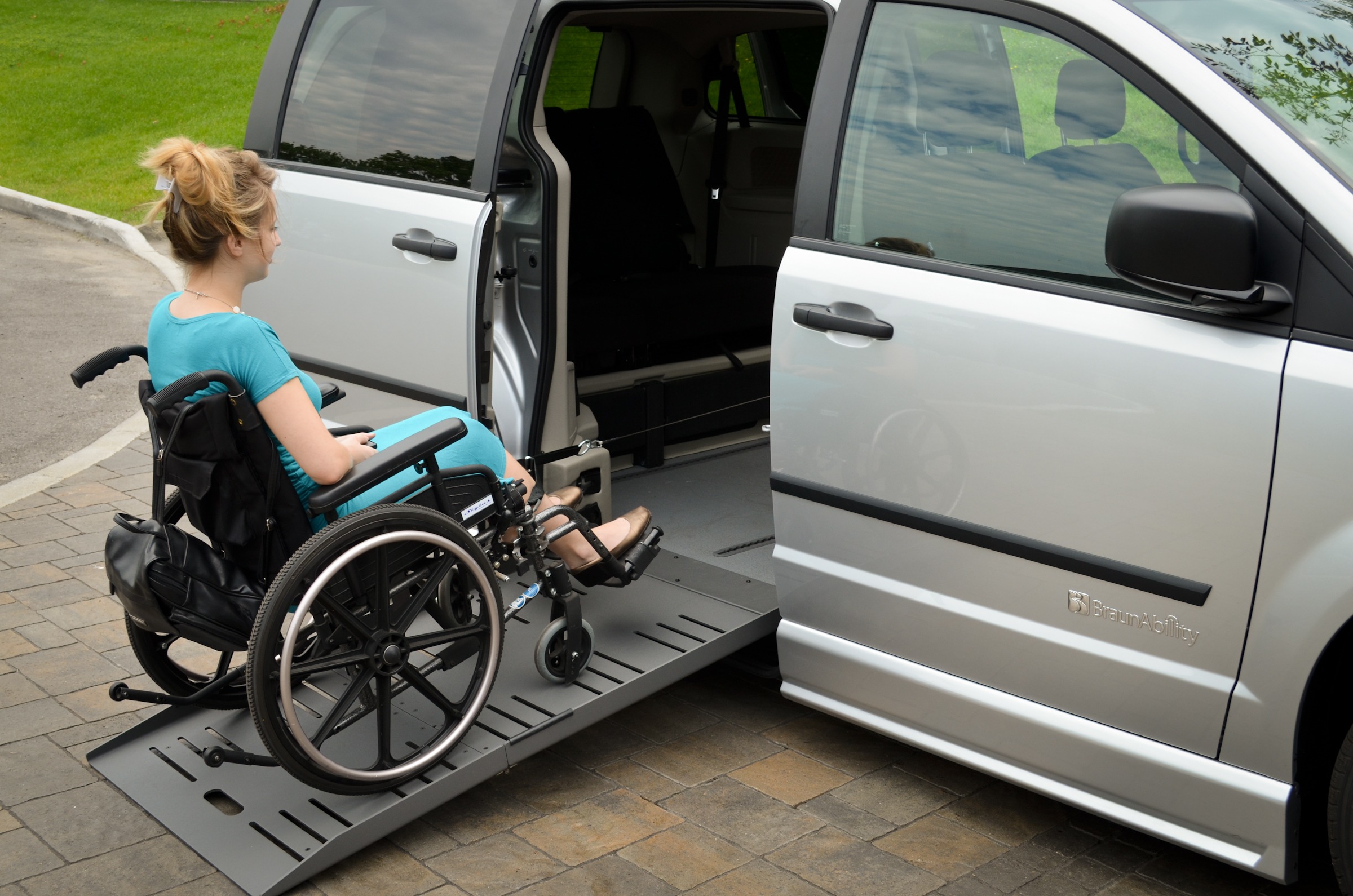 Ramp assist for wheelchair user