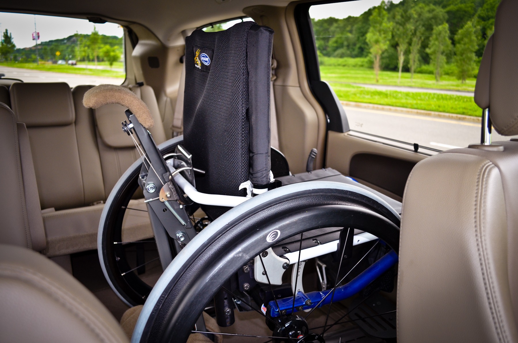 The SPEEDY-LIFT installed in the second row of a minivan with a rigid frame wheelchair locked into position
